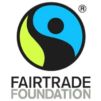 Logo of the Fairtrade Foundation featuring a stylized person shape in blue and black with a green section, framed in a circular design above the text "FAIRTRADE FOUNDATION", often seen at your favorite café where baristas craft ethically sourced beverages.