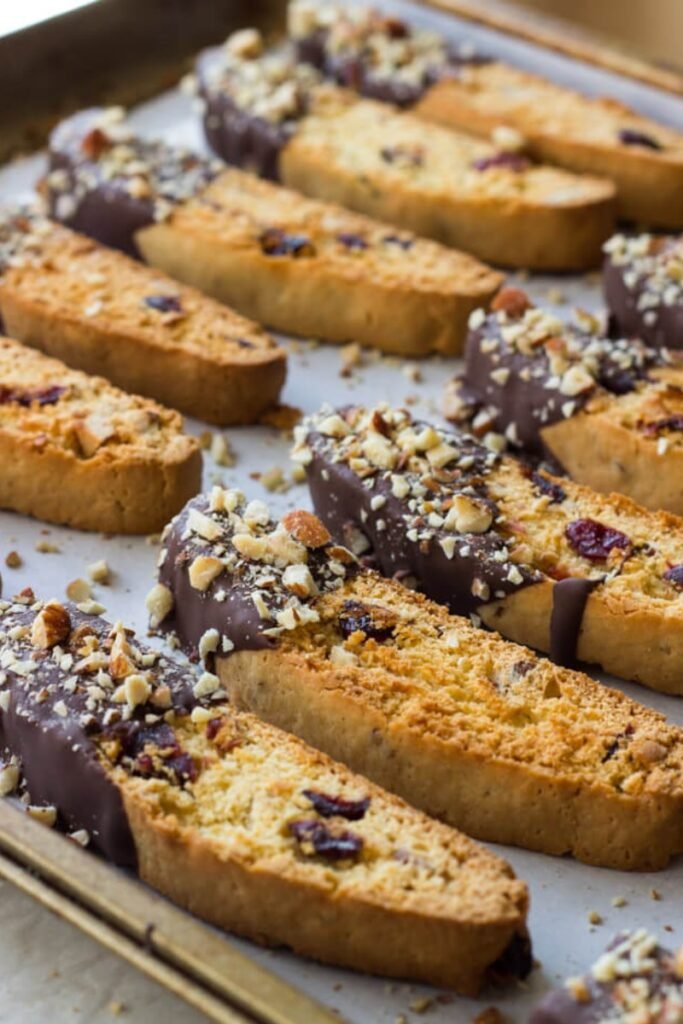 Just from the oven, 10 oval biscotti dipped at one end in delicious dark chocolate and sprinkled with nuts